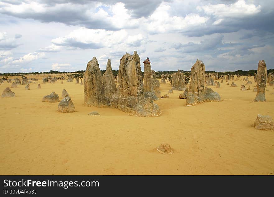 Cheerful man in embrace with a rock. Pinnacles desert. Western Australia. Cheerful man in embrace with a rock. Pinnacles desert. Western Australia