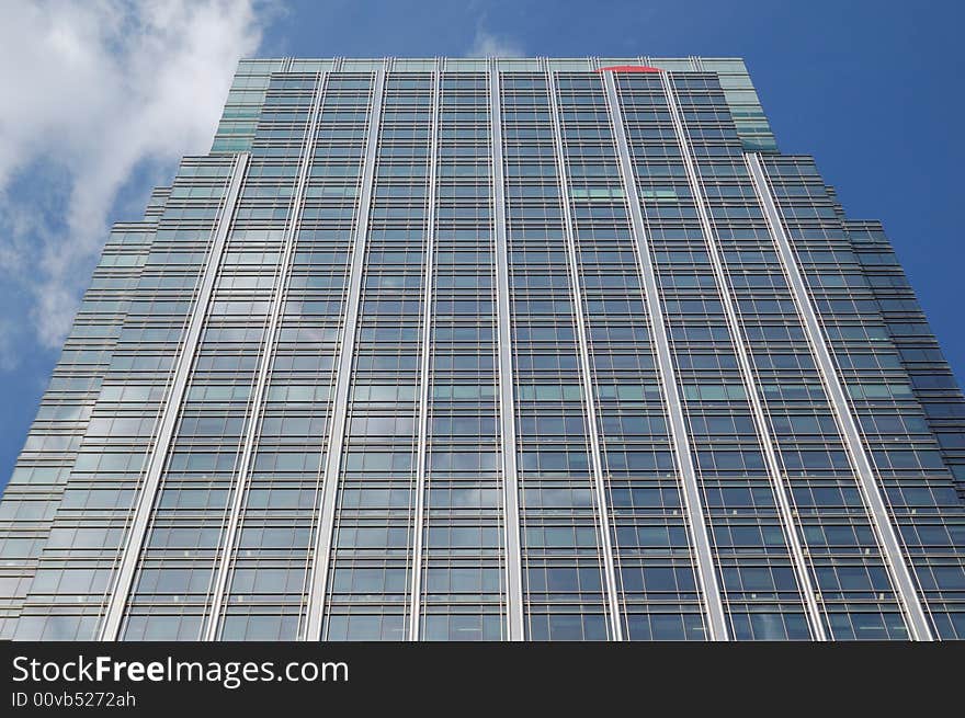 Vertical view of a skycraper with a blue sky background. Vertical view of a skycraper with a blue sky background