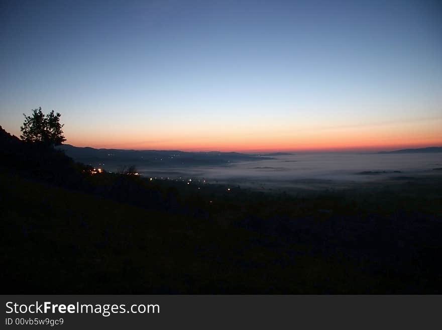 High-wide angle shot of a beautiful dusk scene over the village. Bela Krajina. Slovenia