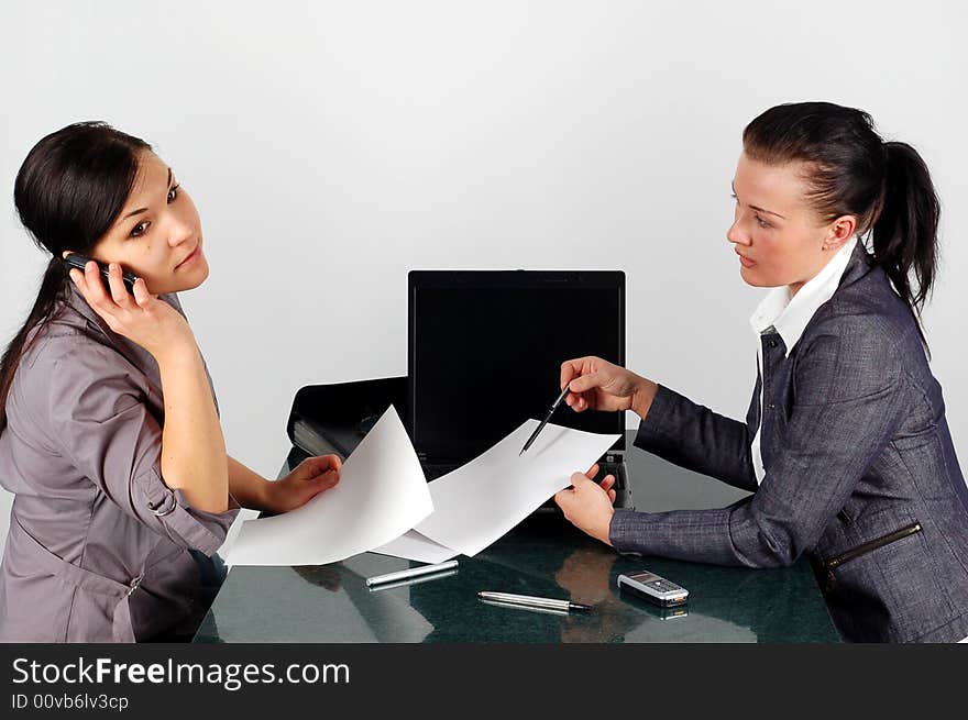 Two brunette woman working in office. Two brunette woman working in office