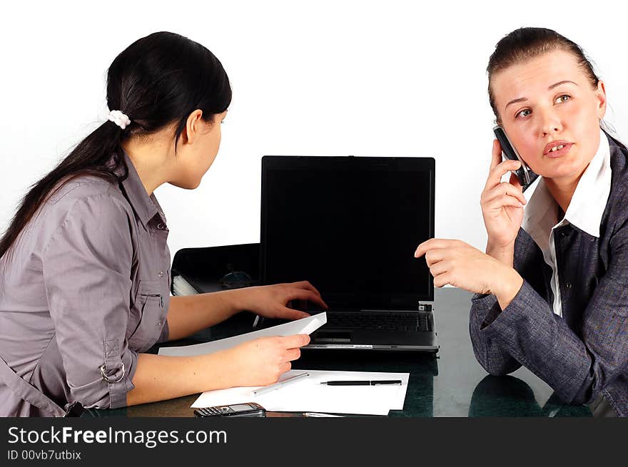 Two brunette women working in office. Two brunette women working in office