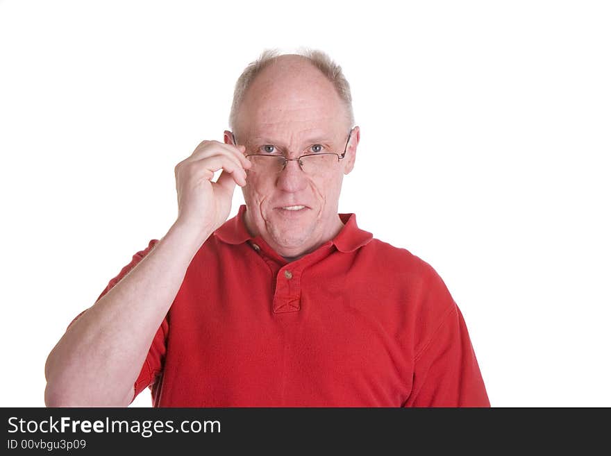 An older bald guy in a red shirt holding his reading glasses. An older bald guy in a red shirt holding his reading glasses