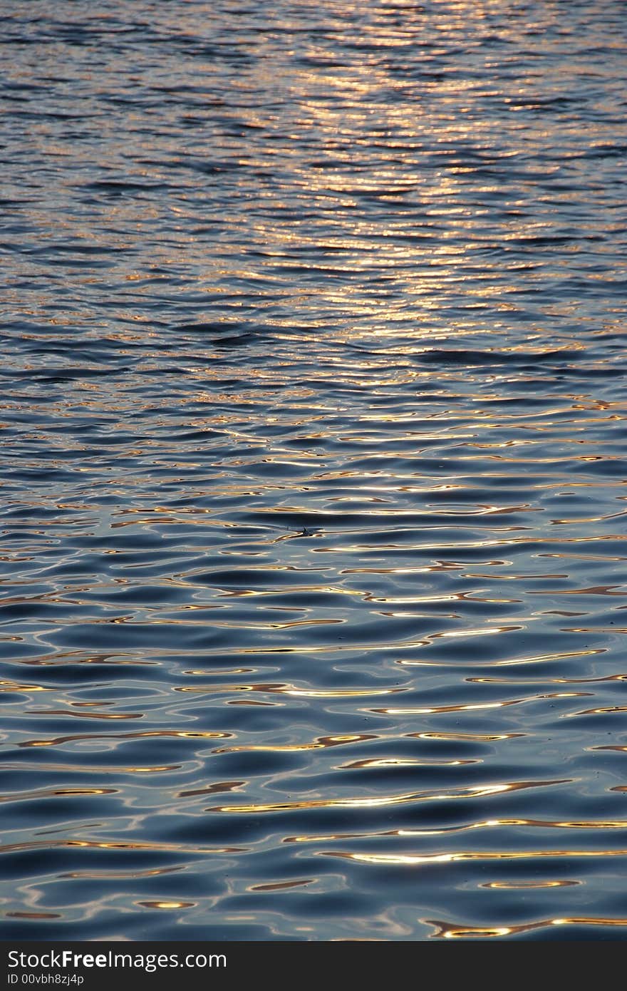 The sun setting reflecting off the waters surface. The sun setting reflecting off the waters surface