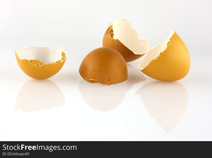 Brown eggshells broken in half, with reflection. Brown eggshells broken in half, with reflection