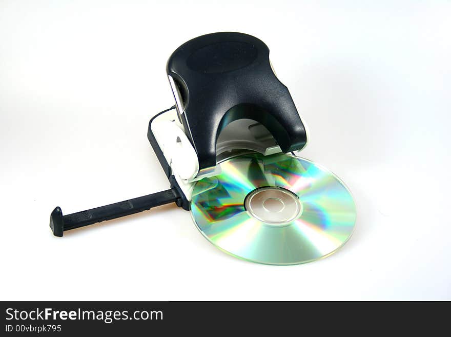 Black perforator with cd or dvd as symbol for office stuff or creative objects. Black perforator with cd or dvd as symbol for office stuff or creative objects.