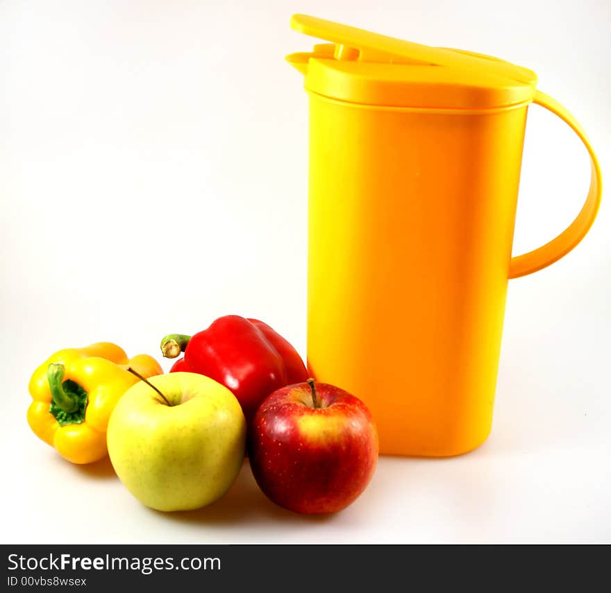 Some apples, paprika and one carafe in red green and yellow as light snack. Some apples, paprika and one carafe in red green and yellow as light snack