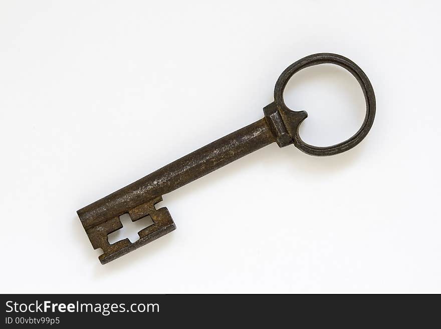 Vintage rusty key isolated at white