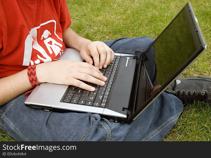 Human hand pressing a key on a laptop keyboard. Human hand pressing a key on a laptop keyboard