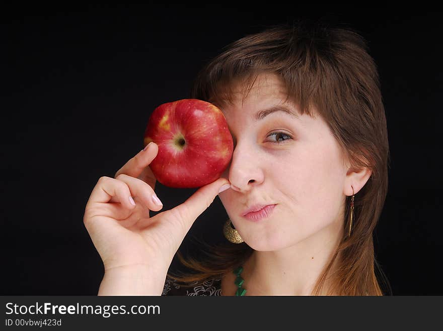 Woman with apple near her eyes. Woman with apple near her eyes