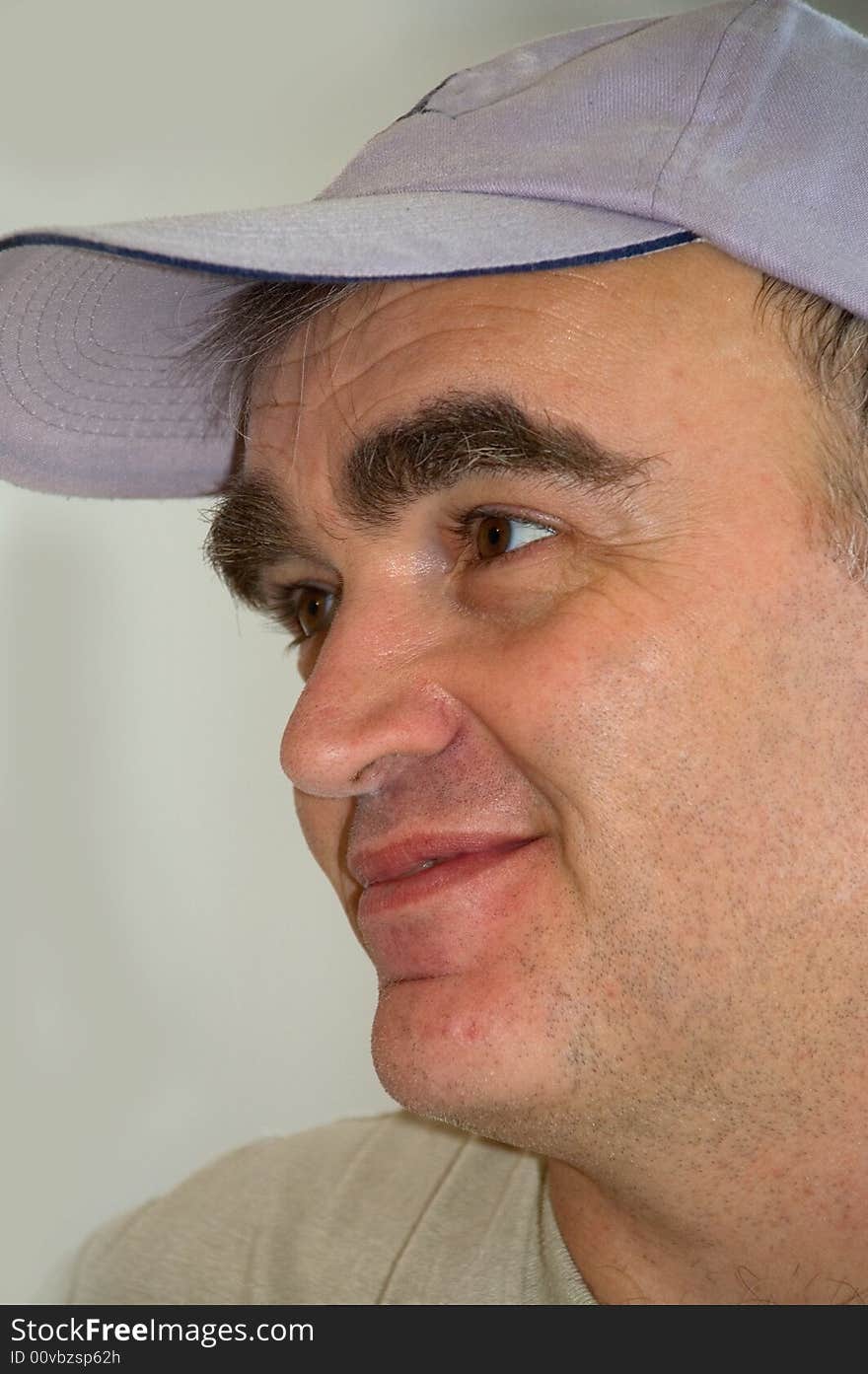 Worker's portrait in a cap with bushy eyebrows