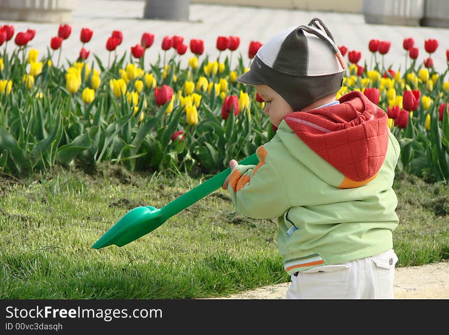 Child with spade in the garden