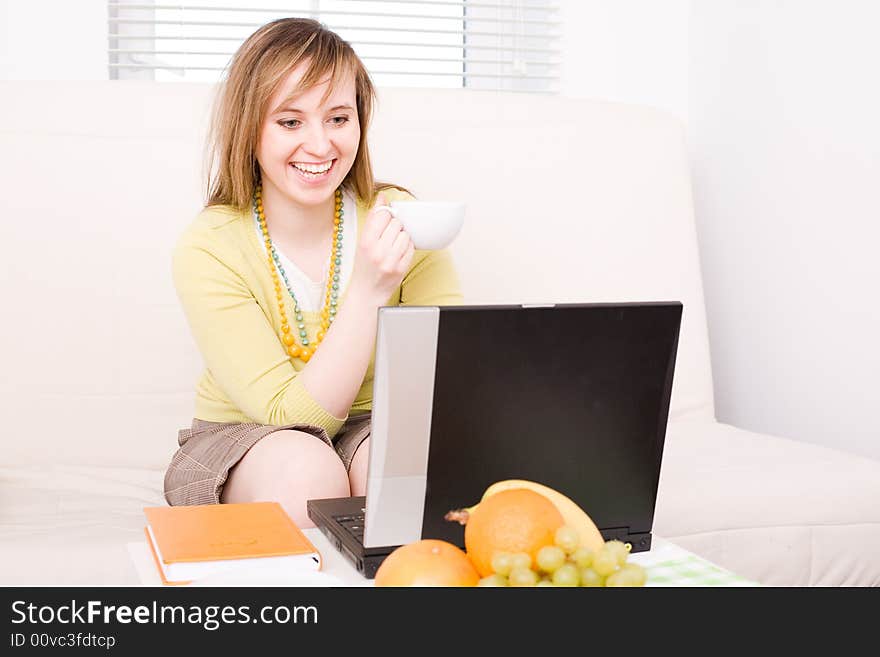 Portrait of smiling woman with laptop / at home