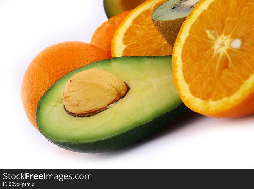 Fresh avocados with other fruits  isolated on white background