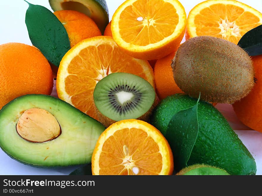 Fresh avocados with other fruits isolated on white background