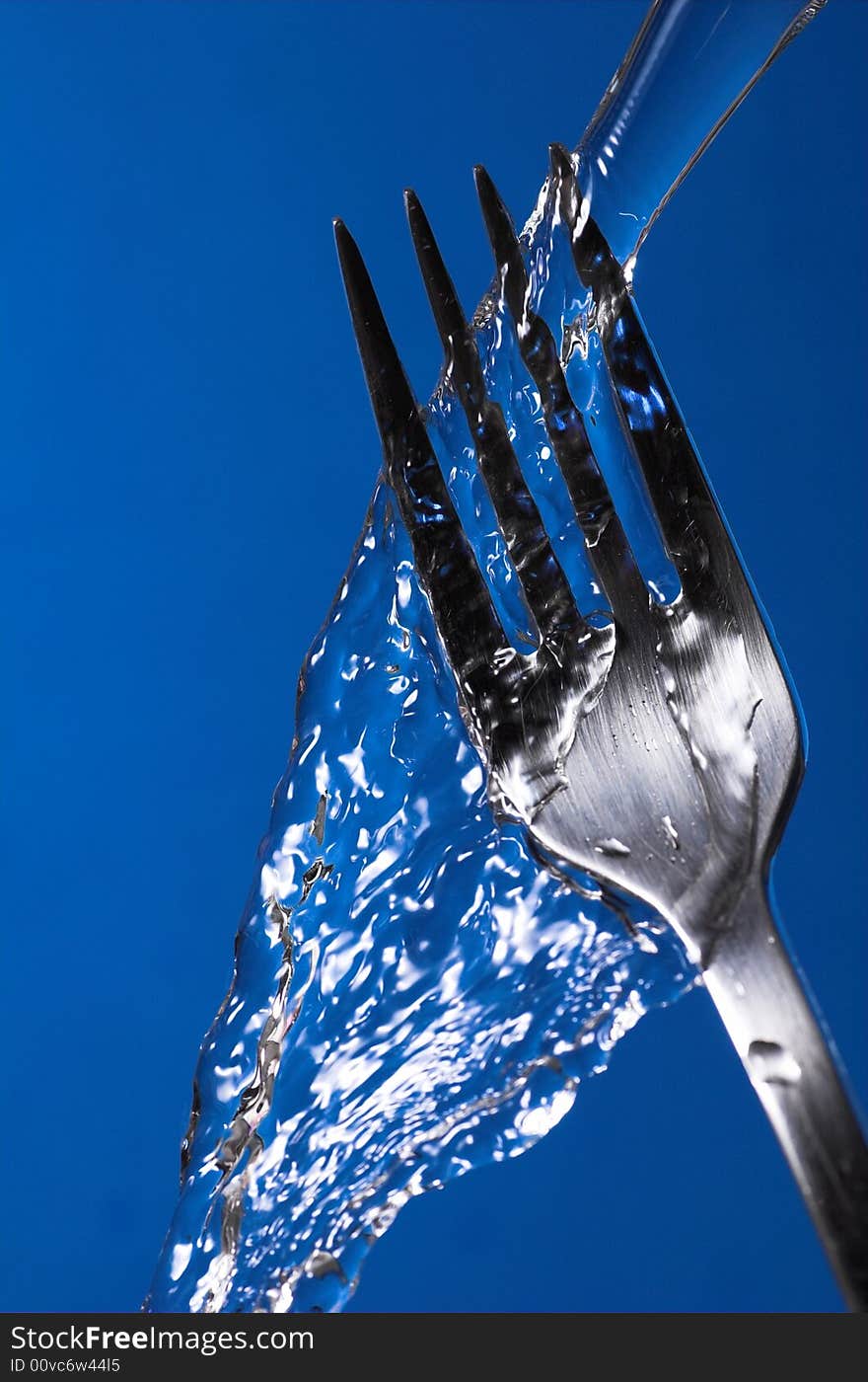 Fork under water over blue background - hygiene concept