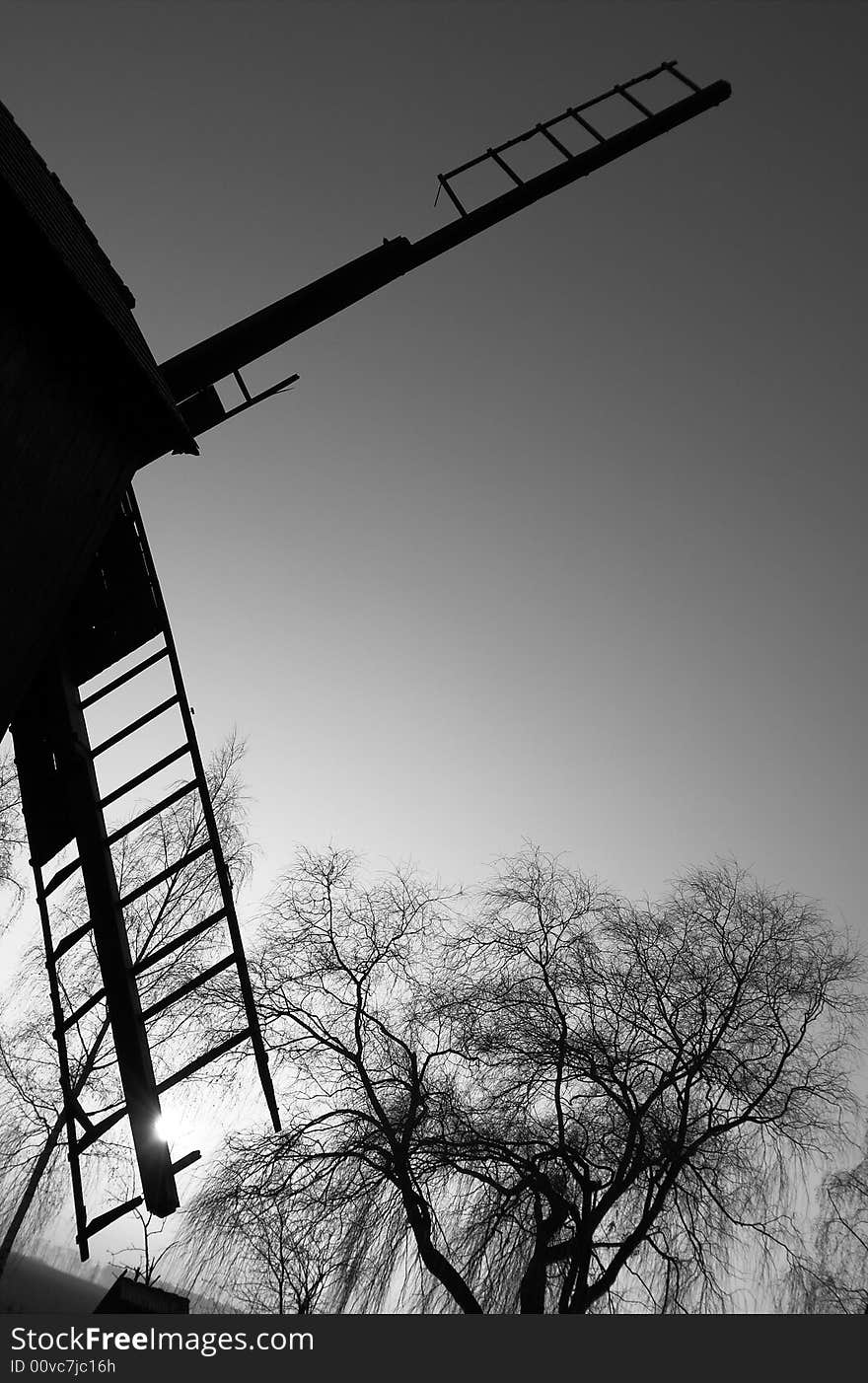 Old windmill in sunset, black and white