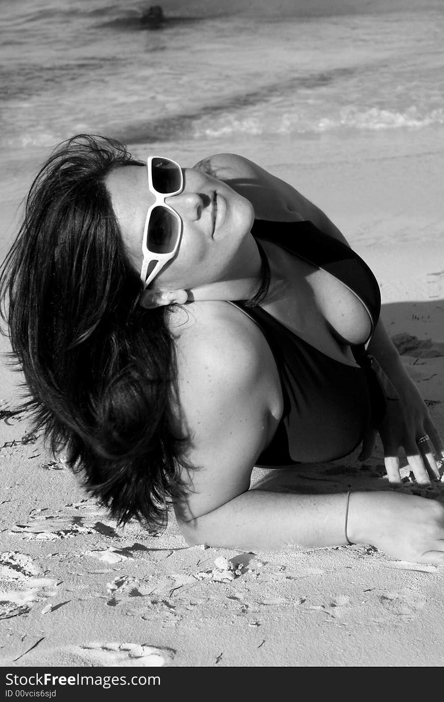 Black and white photo of a swimsuit model on the beach. Black and white photo of a swimsuit model on the beach.