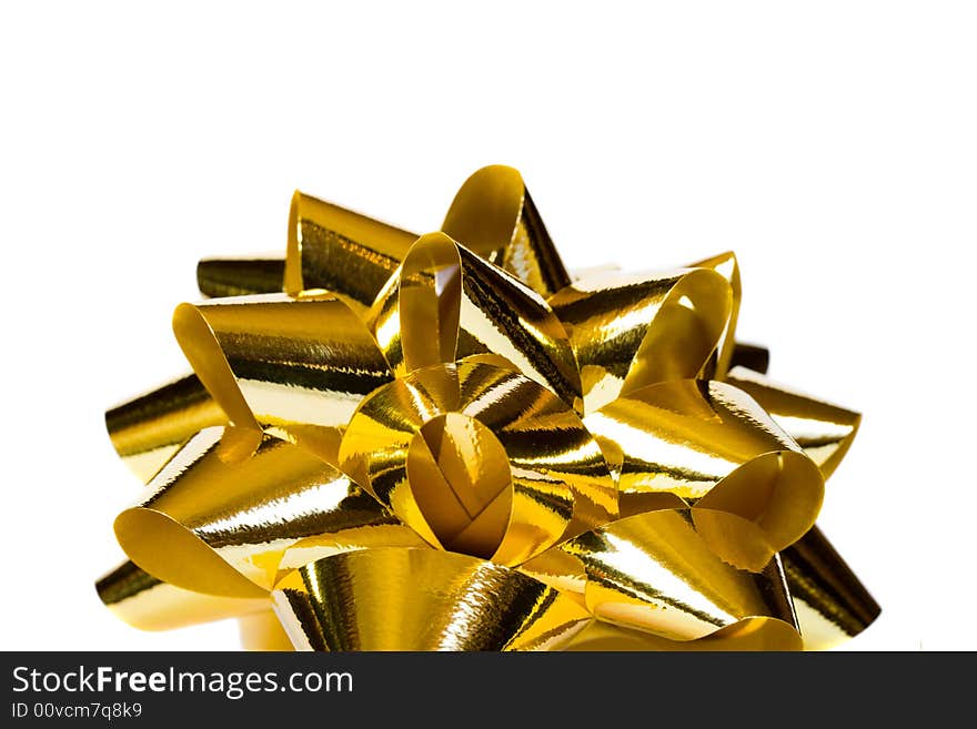 Macro of gold bow, isolated on white background