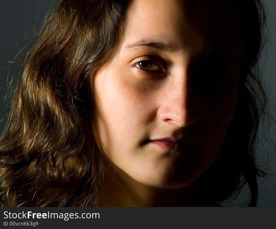 Low-key portrait about a pretty girl with brown hair. Low-key portrait about a pretty girl with brown hair