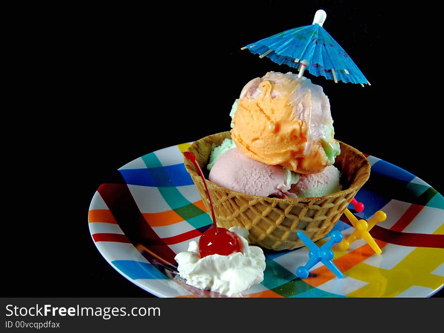 Waffle bowl filled with rainbow sherbet. Waffle bowl filled with rainbow sherbet.