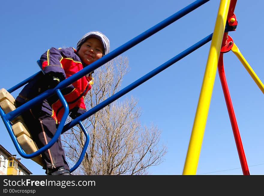 The Boy on seesaw, high. Rejoices, smiles. The Boy on seesaw, high. Rejoices, smiles.