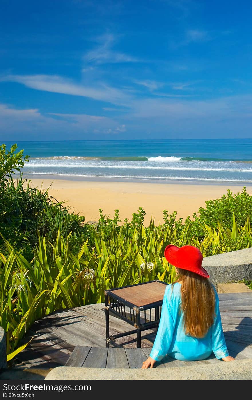 Woman in red hat on the tropical beach