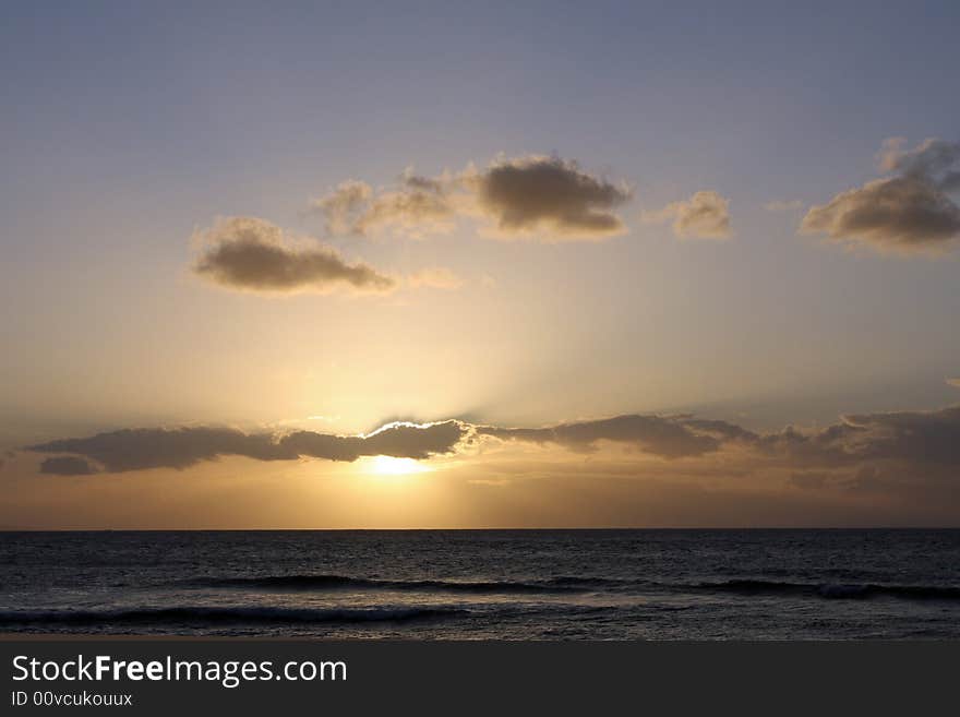 The sun setting over the Pacific Ocean in Maui. The sun setting over the Pacific Ocean in Maui.