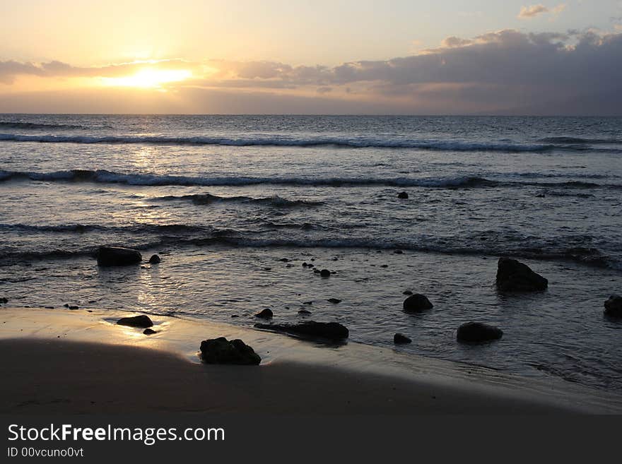 The beach and rock landscape as the sun sets in Maui. Focus on shoreline. The beach and rock landscape as the sun sets in Maui. Focus on shoreline