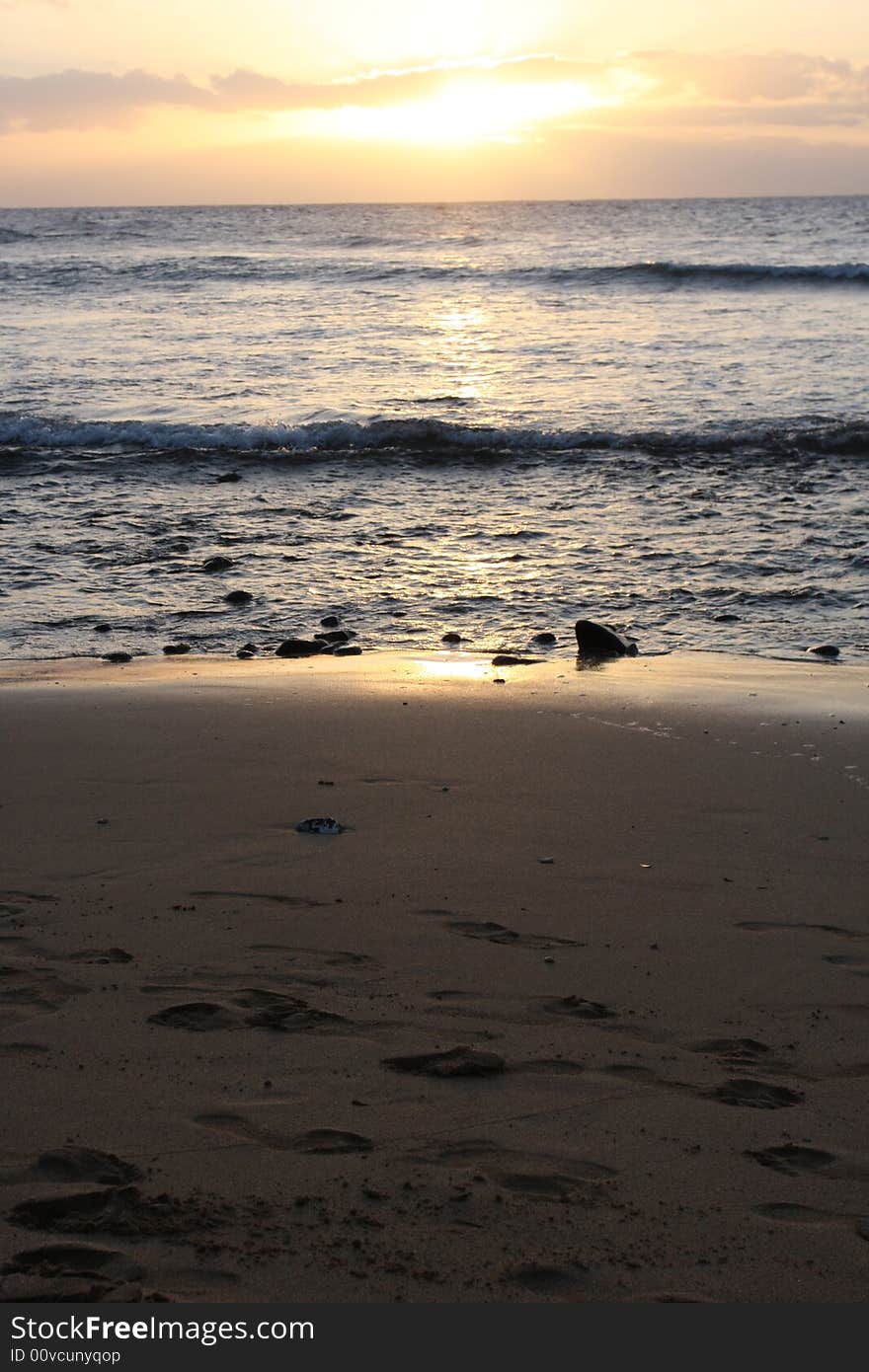 The beach and rock landscape as the sun sets in Maui.  Focus on shoreline. The beach and rock landscape as the sun sets in Maui.  Focus on shoreline