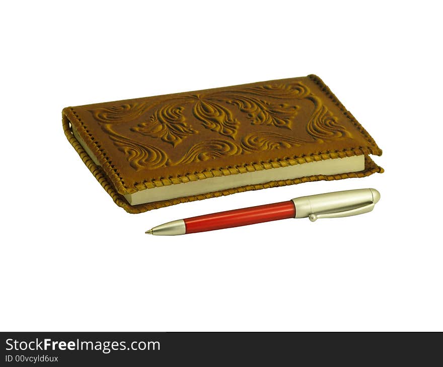 Brown soft leather covered notebook and a pen on a white background