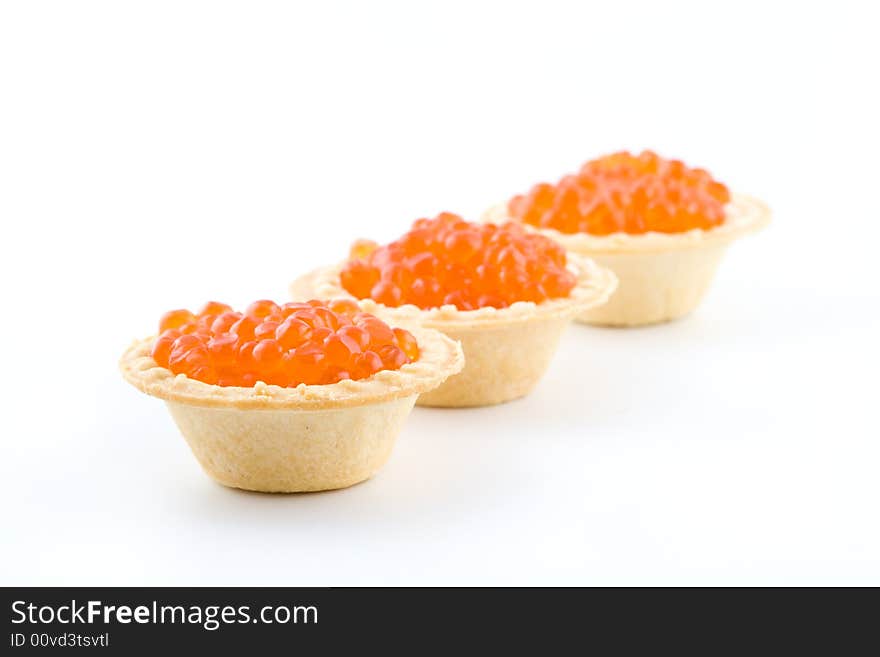 Tartlets with red caviar isolated on a white background. Tartlets with red caviar isolated on a white background