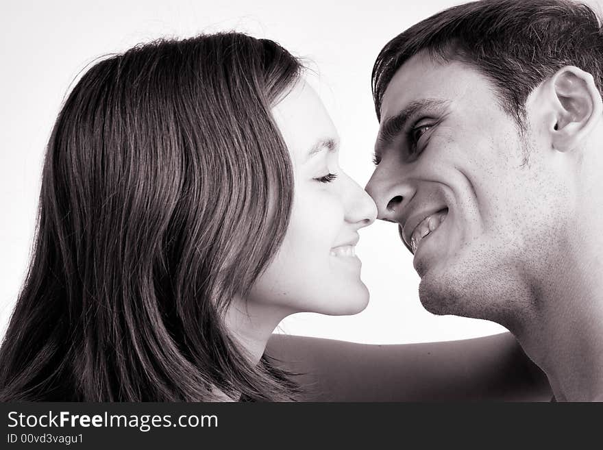 Young adult couple in the studio kissing. Young adult couple in the studio kissing