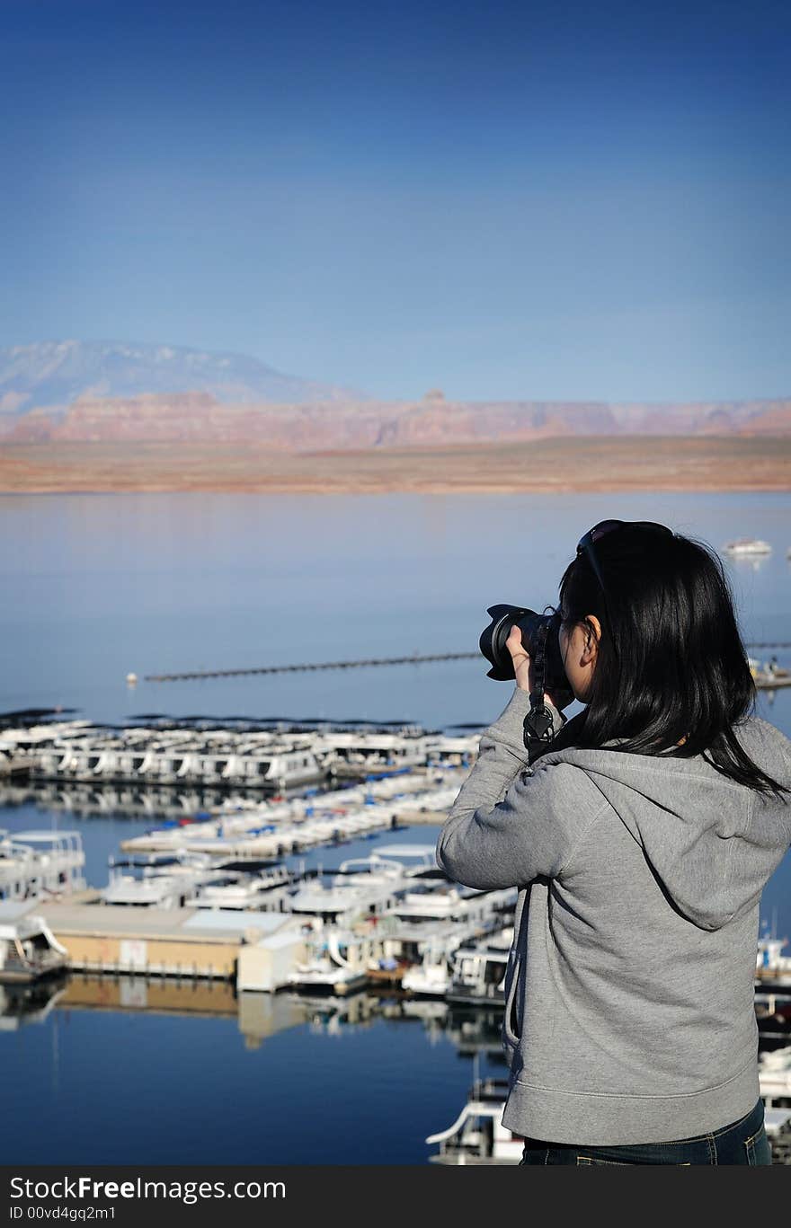 A woman photographer focusing on her subject. A woman photographer focusing on her subject