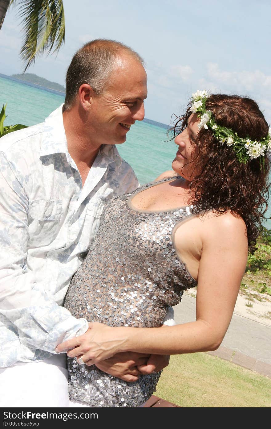 Portrait of a happy couple in an embrace during their tropical destination vacation.