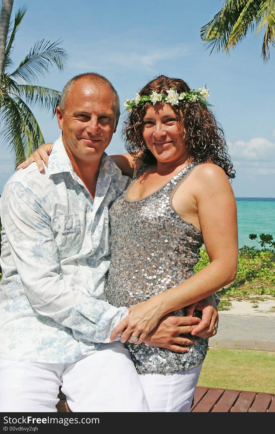 Portrait of a happy couple in an embrace during their tropical destination vacation.