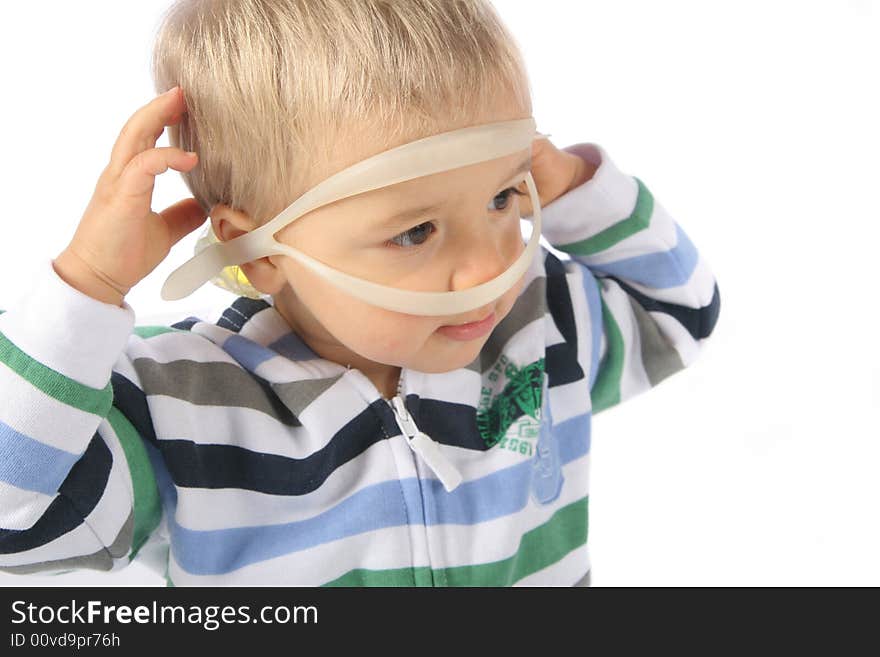 Child with swimming glasses on his head