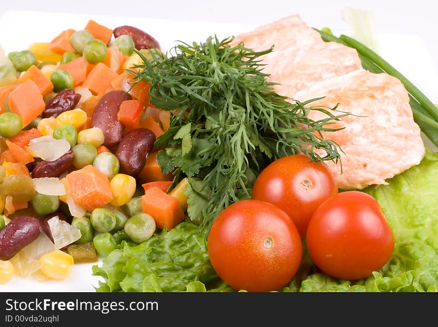 Stake from a salmon with vegetables on a plate