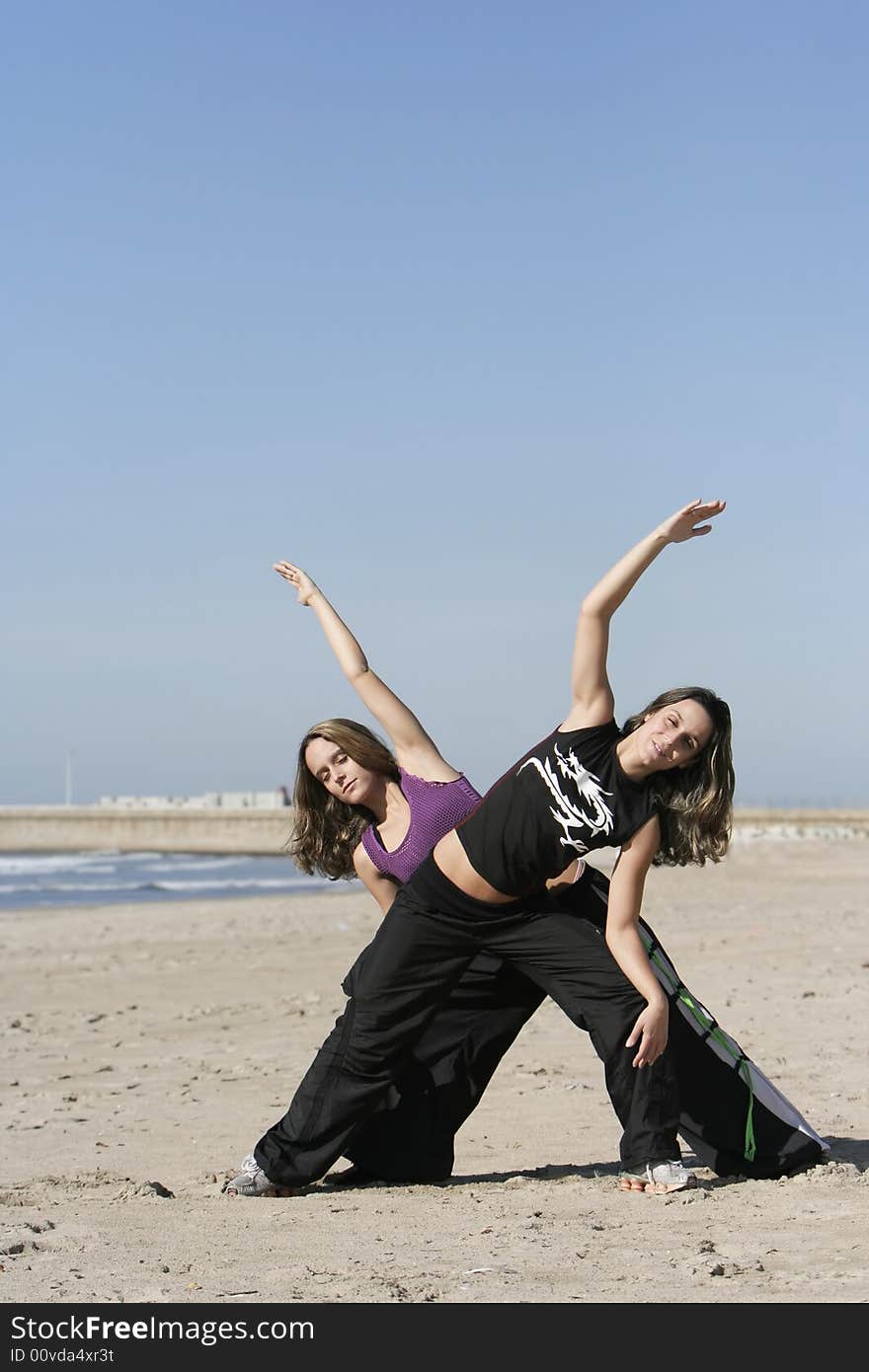 Twins working out in the beach