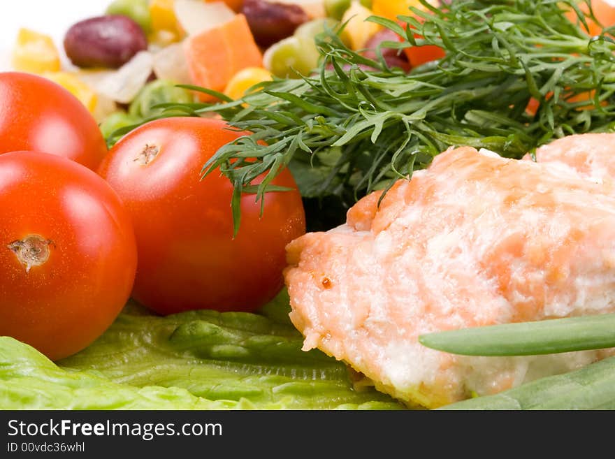 Stake from a salmon with vegetables on a plate