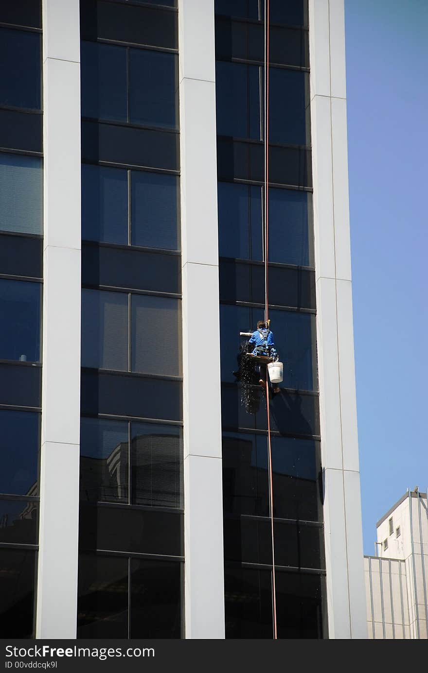 They wash windows in a high office building. They wash windows in a high office building.