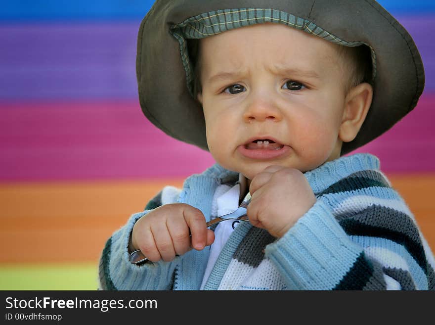 A boy with spoon on the colorful background. A boy with spoon on the colorful background