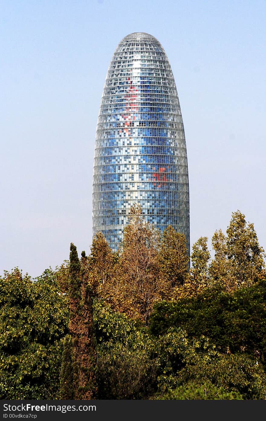 Agbar tower rising above trees in barcelona. Agbar tower rising above trees in barcelona