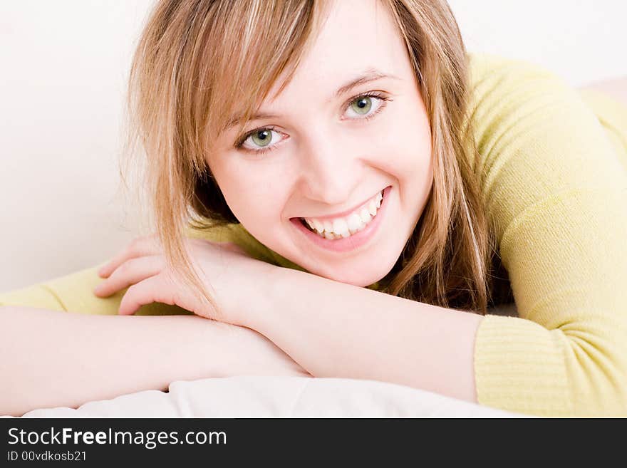 Beautiful young smiling woman relaxing at home. Beautiful young smiling woman relaxing at home