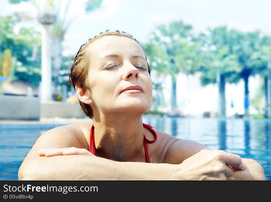 Portrait of nice young woman relaxing in swimming pool. Portrait of nice young woman relaxing in swimming pool