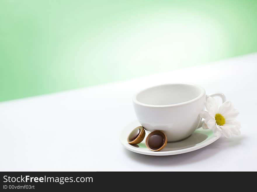 White cup on the green background / copyspace