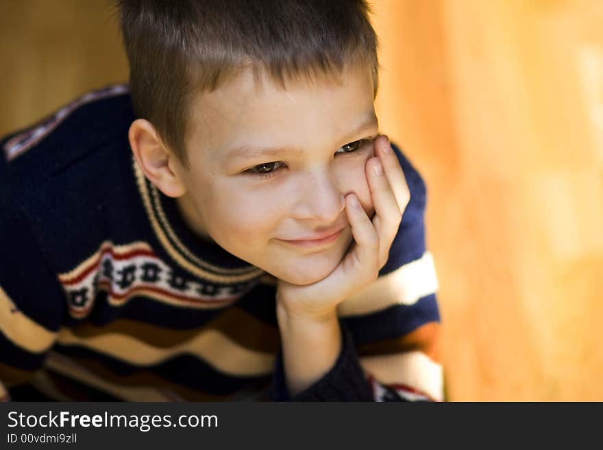 Sitting boy with smiley face on light background