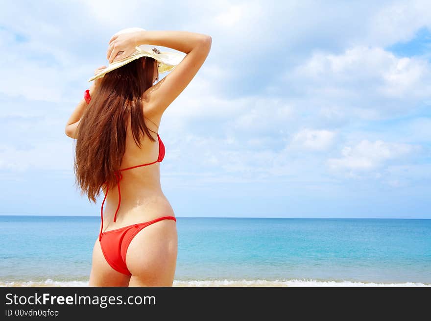 View of wet female back on a background of the tropical sea. View of wet female back on a background of the tropical sea