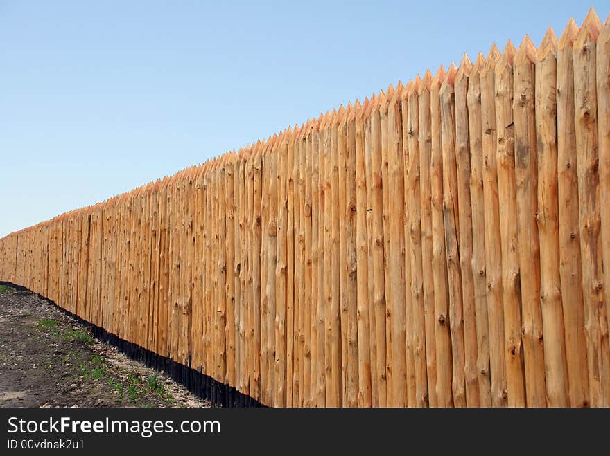 Wooden paling from the sharp raw logs