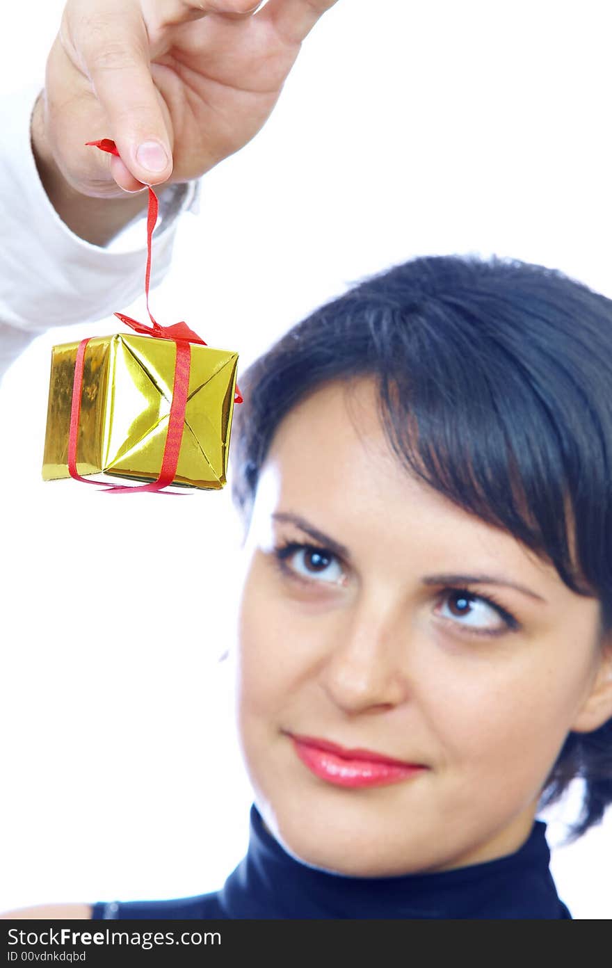 portrait of young brunette hunting for gift.  Focused on box. portrait of young brunette hunting for gift.  Focused on box.