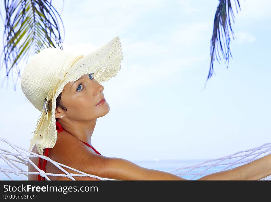 View of nice woman lounging in hammock in tropical environment. View of nice woman lounging in hammock in tropical environment